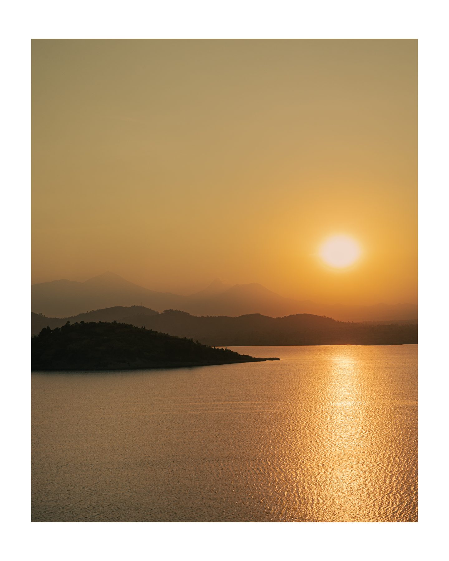 Sunset over Lake Ruhondo and the surrounding volcanoes