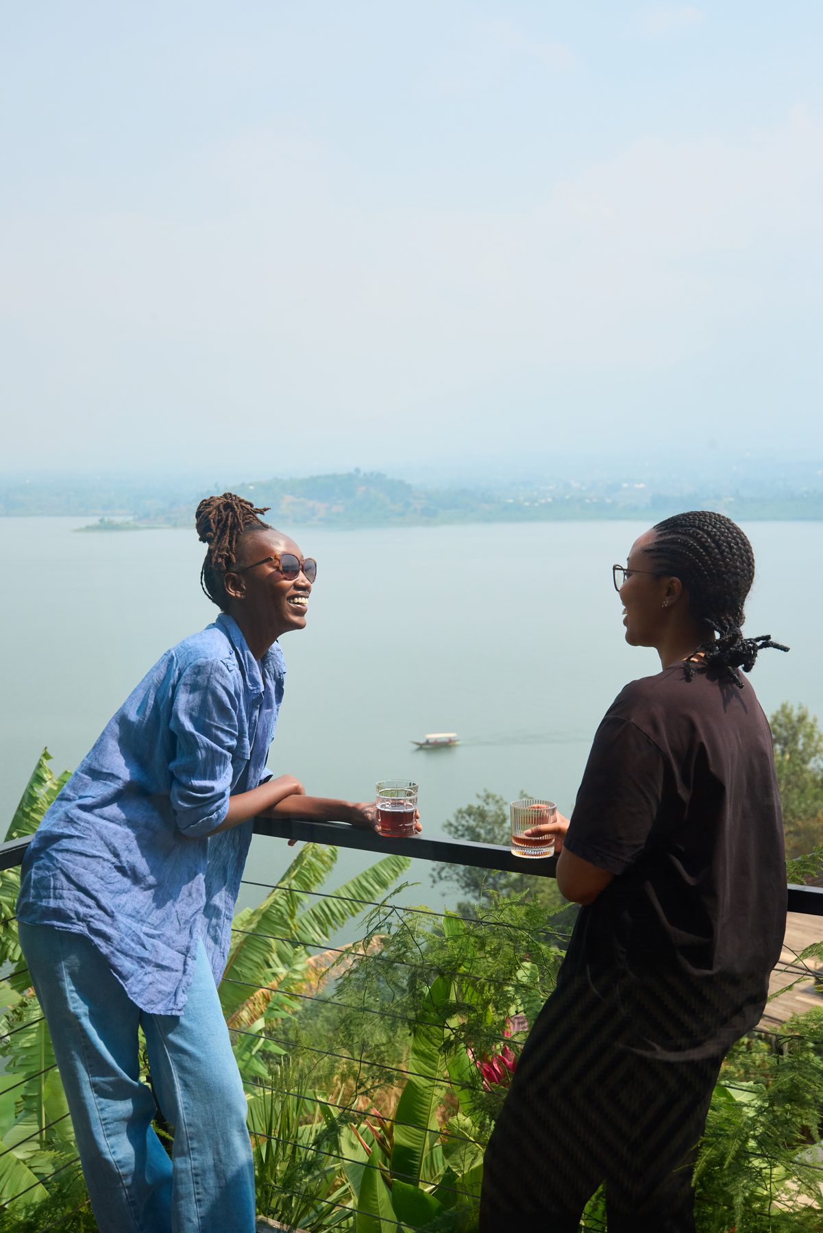 Guests enjoying drinks on the terrace overlooking the lake